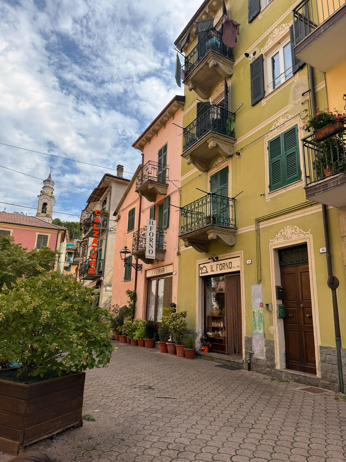 Pastel houses and a bell tower in the village of Cabella